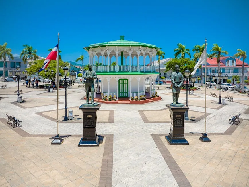 Central Park gazebo and colonial statues in Puerto Plata, Dominican Republic, under a bright midday sky