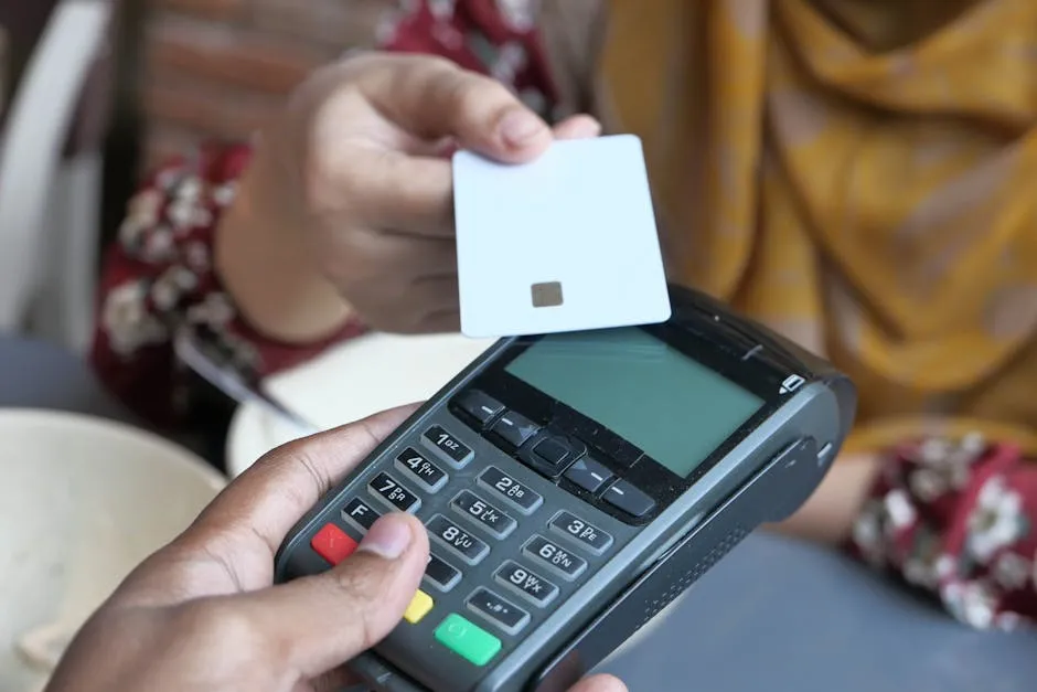 Contactless credit card being tapped on a payment terminal in a shop