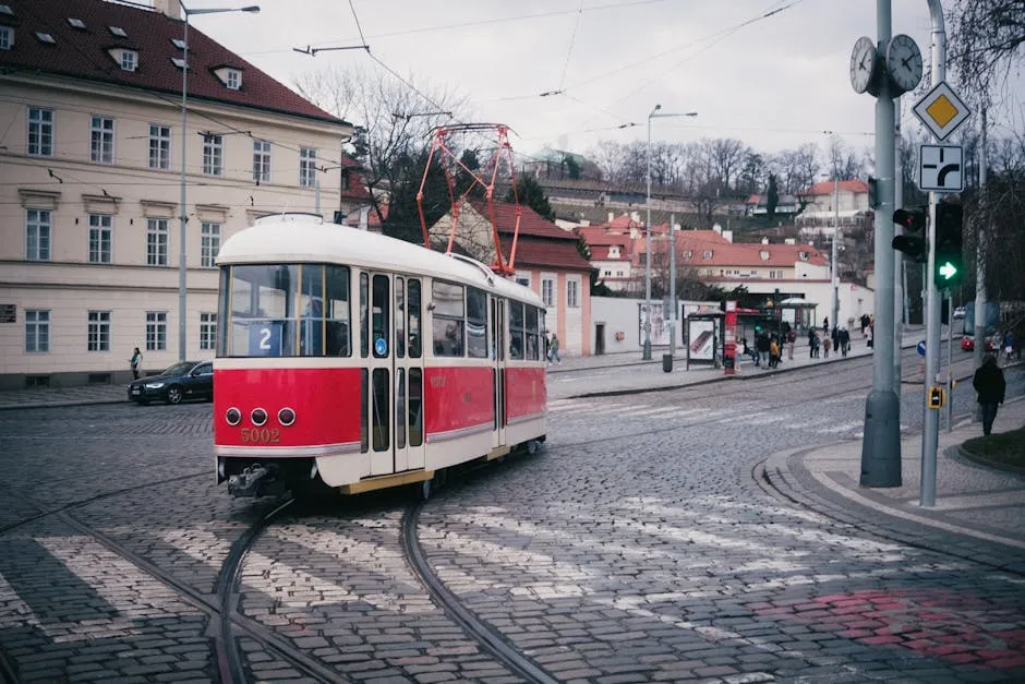 Traditional red tram on historic cobblestone streets in Prague, Czech Republic