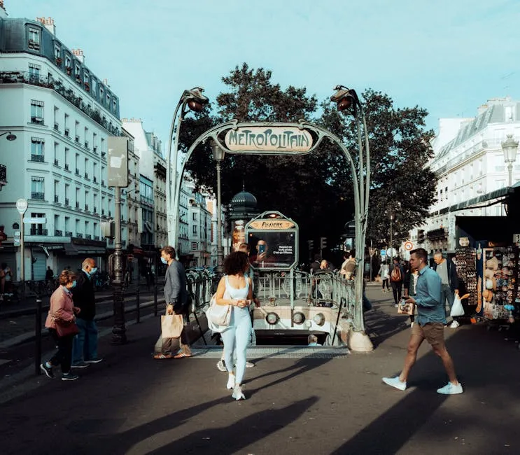 Paris Metro entrance with pedestrians on a city street