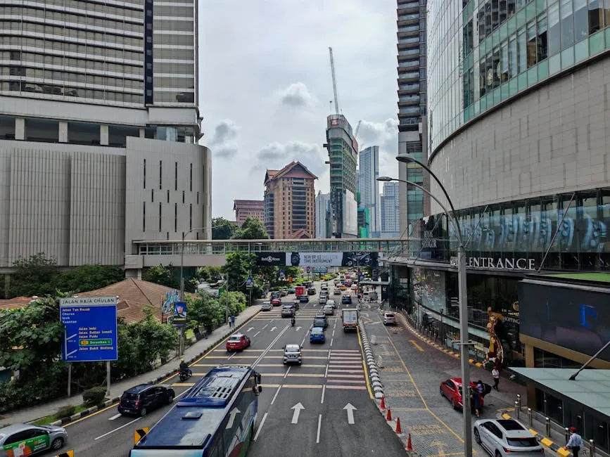 Busy Kuala Lumpur street traffic with Petronas Towers backdrop
