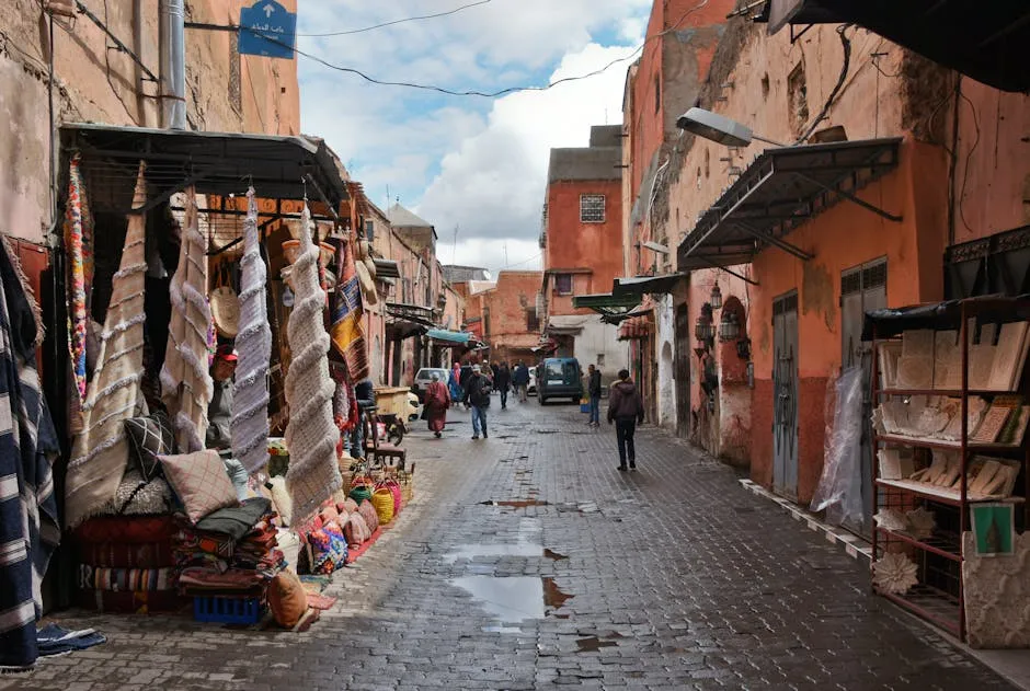 Bustling Marrakech medina street with colourful fabrics and traditional architecture