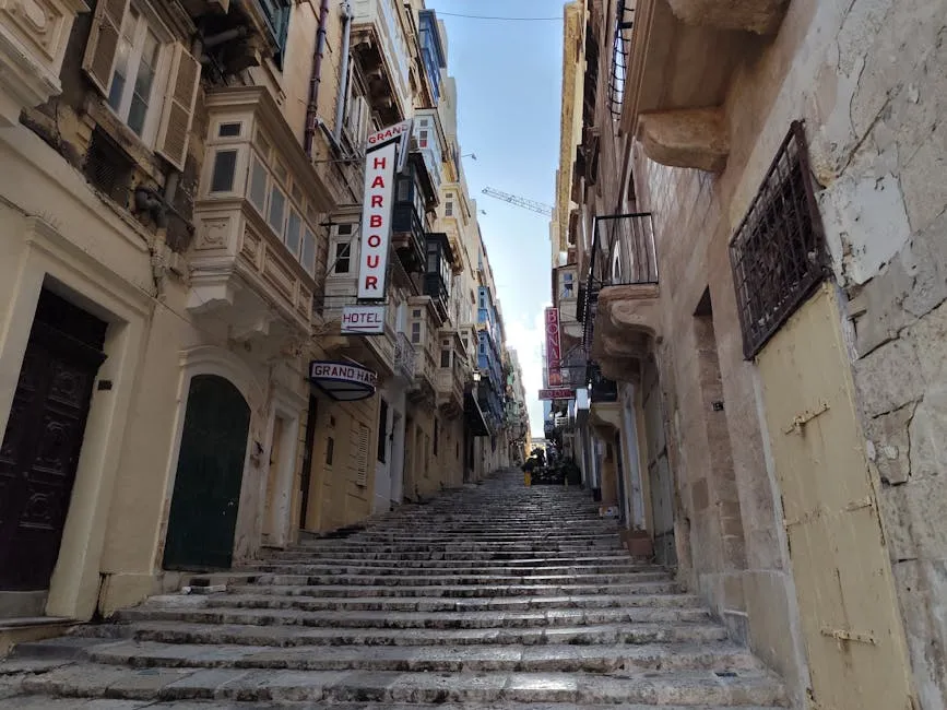 Street in Valletta, Malta with traditional Maltese balconies and stone architecture