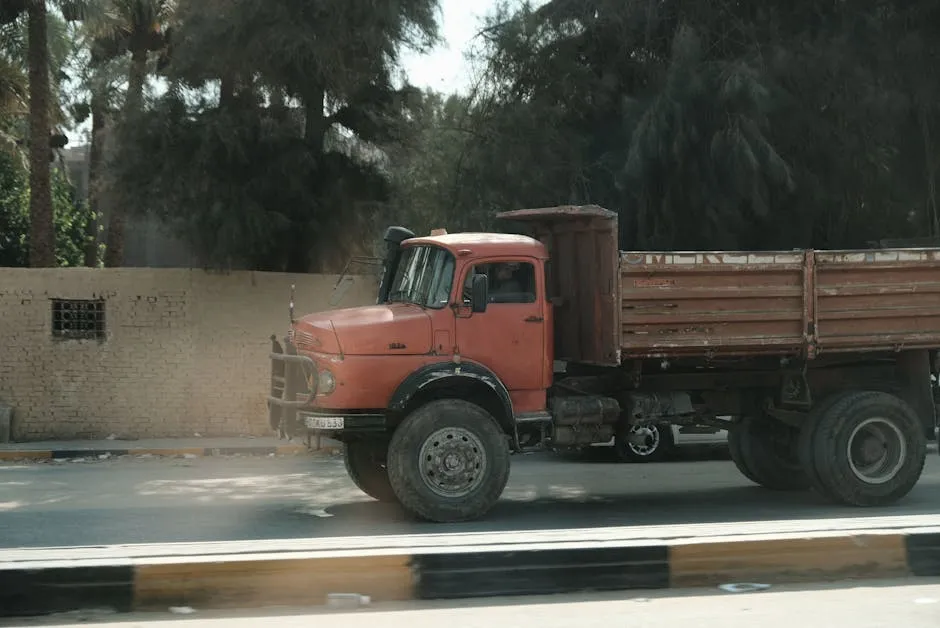 A sunlit Cairo street with vintage red truck and palm trees - typical Egypt travel scene