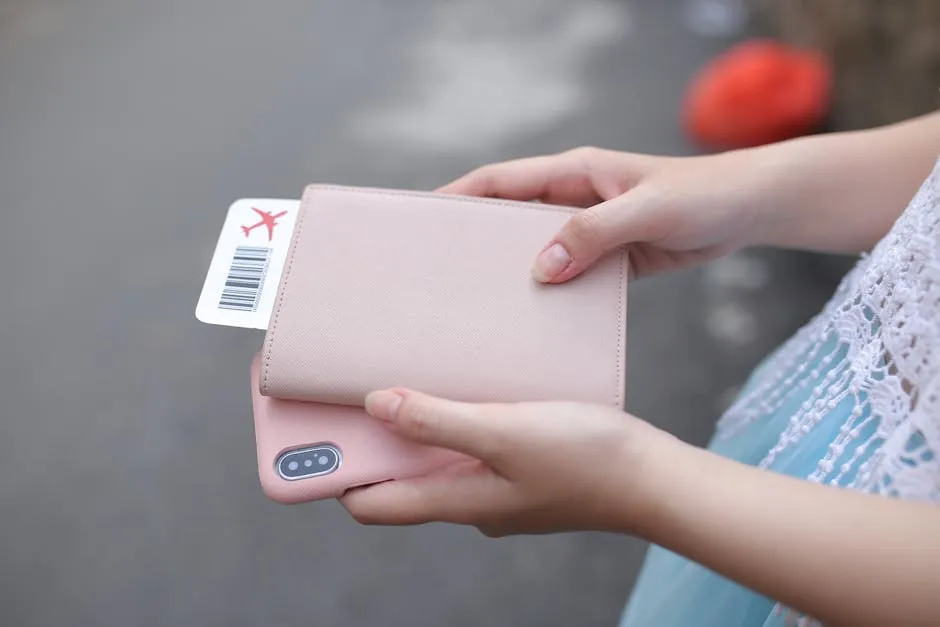 Traveller holding passport, boarding pass, and smartphone ready for Vietnam trip