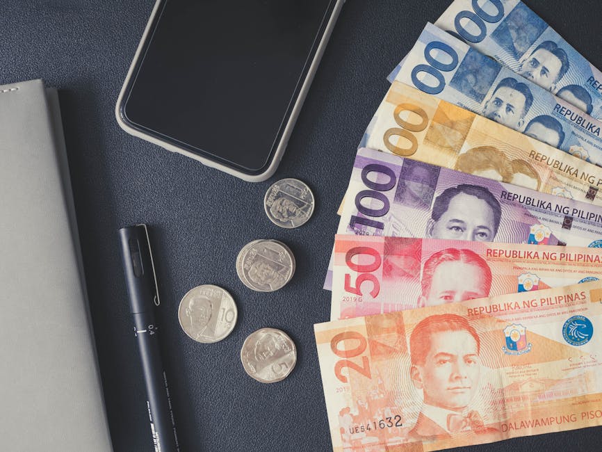 Philippine peso bills and coins with smartphone, representing cash payment options in Philippines